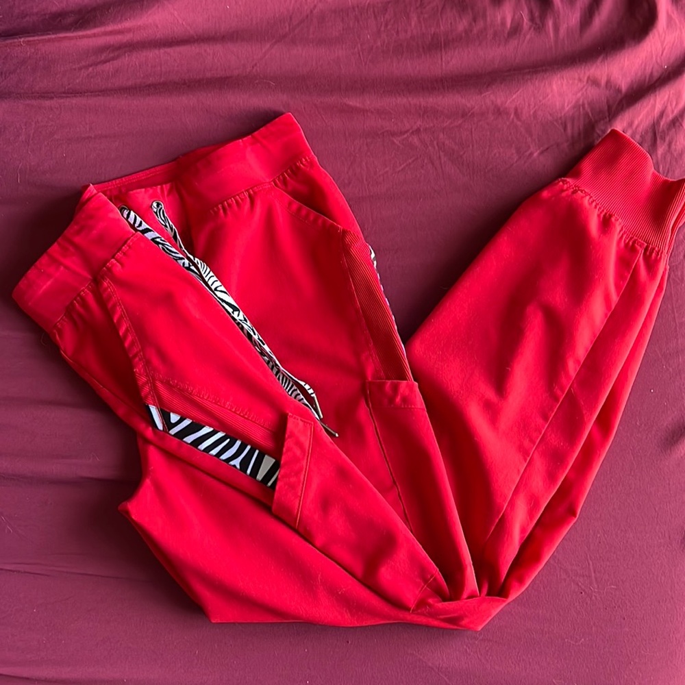 Grey’s Anatomy Red zebra accented jogger scrub pants.